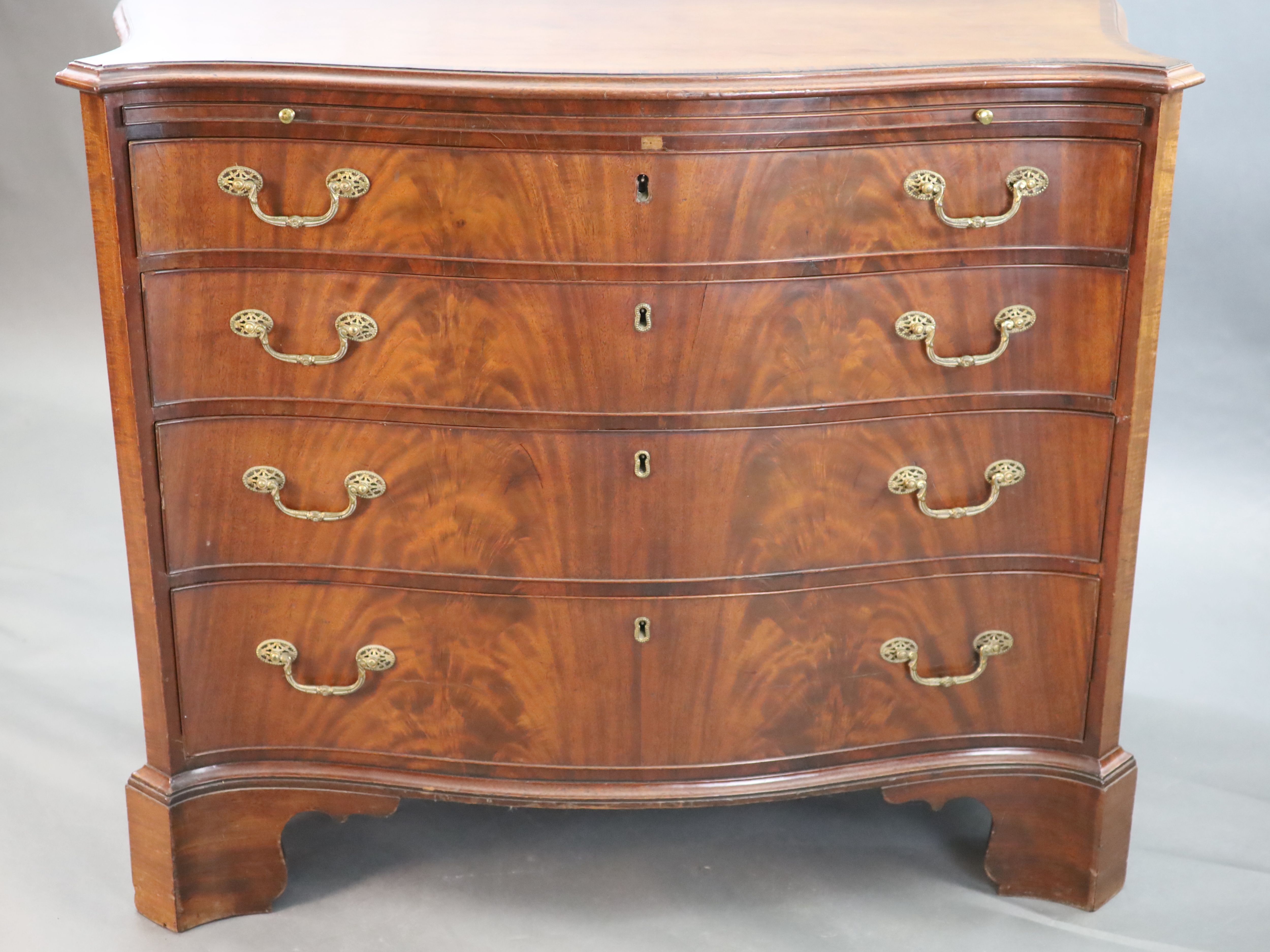 A George III mahogany and rosewood banded serpentine fronted chest, W. 3ft 7in. D. 1ft 10in. H. 2ft 11in.